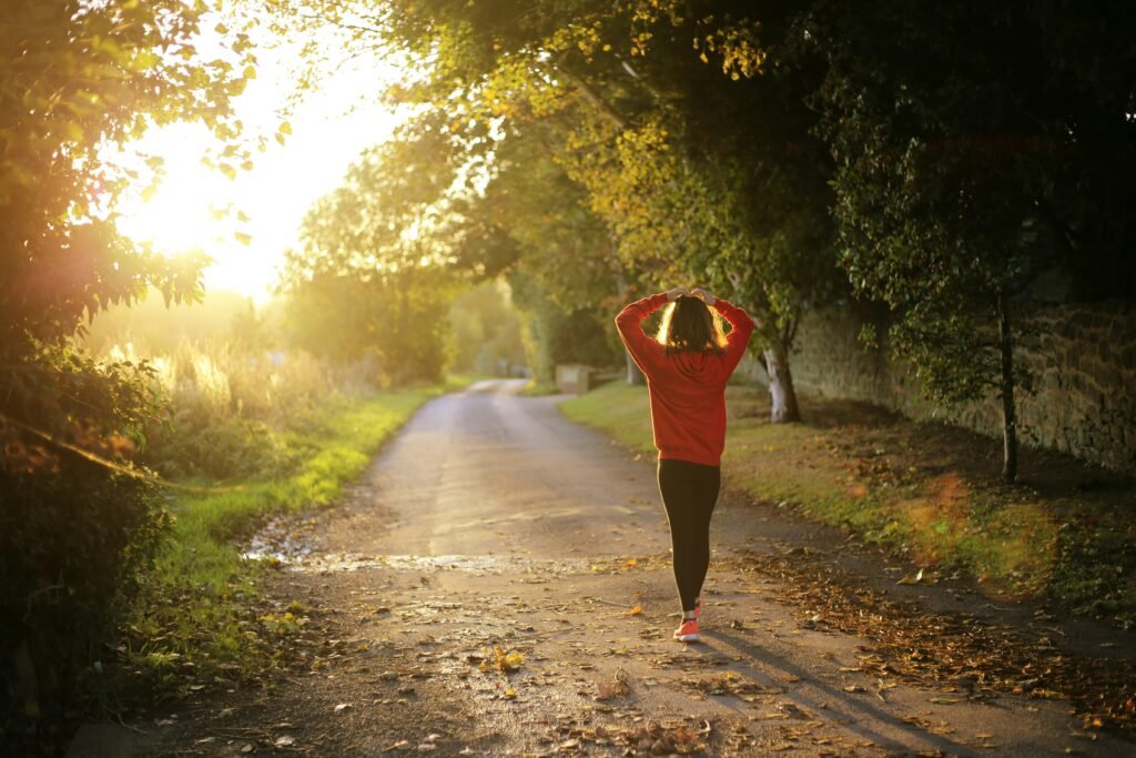Person walking towards the sunset in the distance