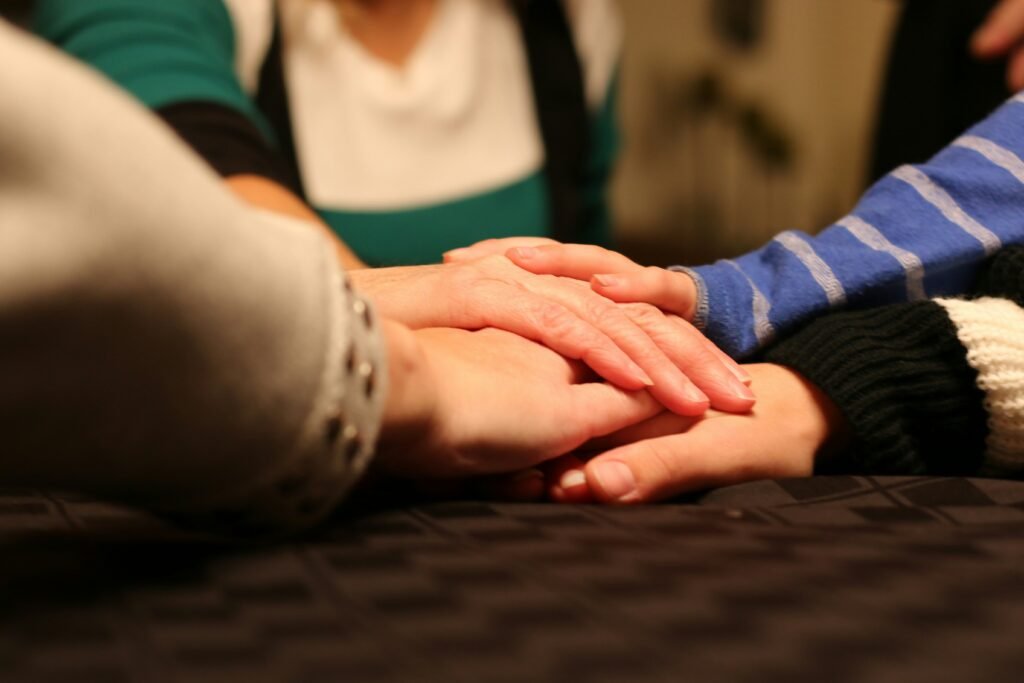 Peoples hands together in support
