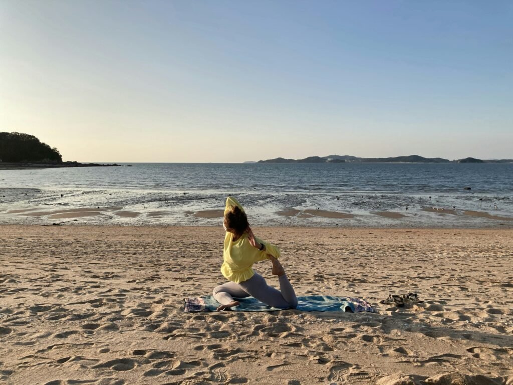 Woman doing yoga on the beach